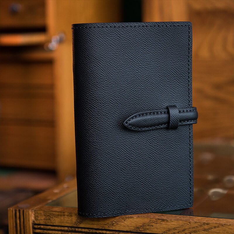 Black leather notebook cover on a desk